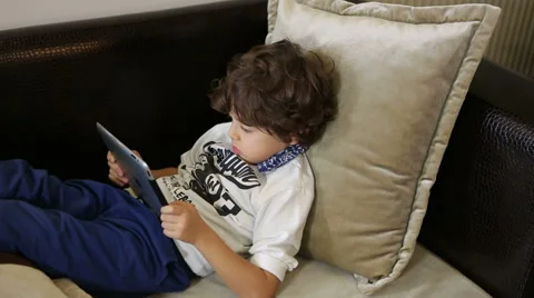 Little boy playing on the tablet computer games Stock Footage 44407764