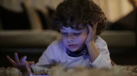 Little boy playing on the tablet computer games Stock Footage 44442238