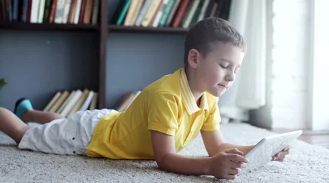 Little boy playing on the tablet computer games Stock Footage 64061786