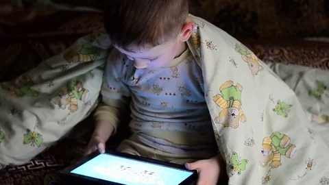 Little boy playing on the tablet computer games Stock Footage 73695633