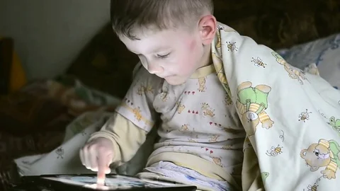 Little boy playing on the tablet computer games Stock Footage 73695749