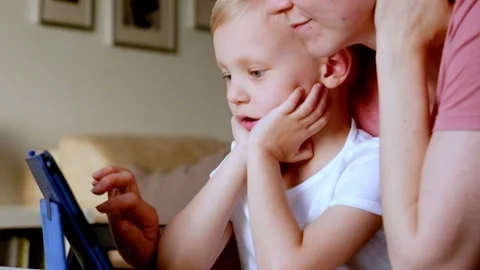Little boy Playing with Tablet PC with his mother 스톡 동영상 90367795