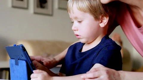 Little boy Playing with Tablet PC with his mother Vídeo Stock 90368493