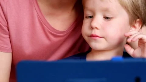 Little boy Playing with Tablet PC with his mother Video stock 90370852