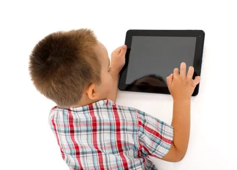 Little boy playing on tablet PC Stock Photos