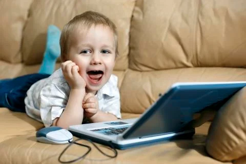 Little boy is playing on the teaching computer Stock Photos