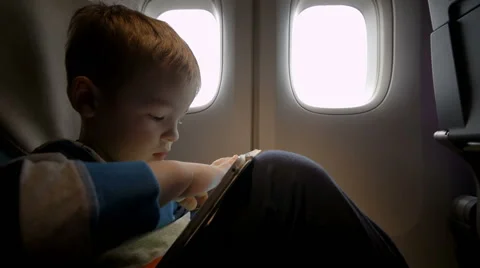 Little boy playing on touch pad in the plane Stock-Footage 45084148