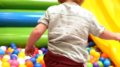 Little boy playing on trampoline colored balls children entertainment center 스톡 동영상 112704141