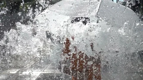 Little boy playing water drops fountain under the cloth and umbrella 스톡 동영상 106485605