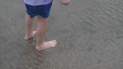Little boy playing with waves on the beach, Bali, Indonesia Stock Footage 234121155