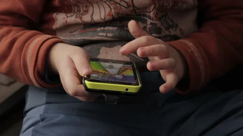 Little boy is playing on your smartphone Stock Footage 59108673