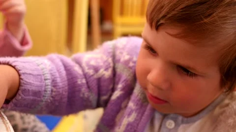 Little boy plays on a cafe table with toys cars Stock Footage 51782122