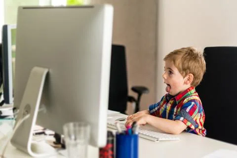 Little boy plays with computer Stock Photos