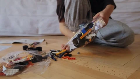 A little boy plays with a constructor at home. Stock Footage 252382325