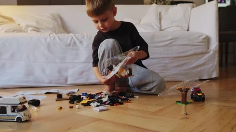 A little boy plays with a constructor at home. Stock Footage 252382354