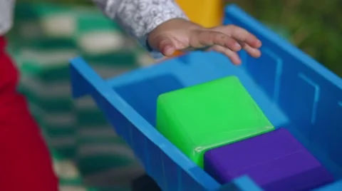 Little boy plays with cubes and machine in the garden Stock Footage 69060293