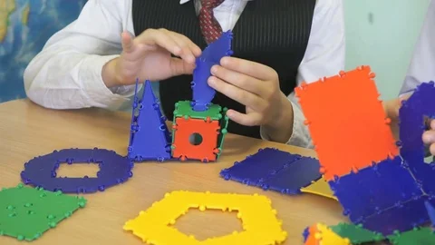 Little boy plays developing toy designer indoors Vídeo Stock 80983977