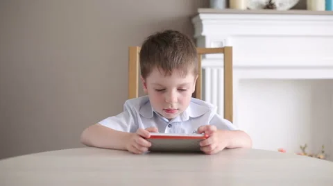 Little Boy Plays on a Mobile Device Stock Footage 66234732