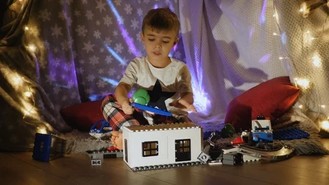 Little boy plays with plastic constructor at home Stock Footage 123518937