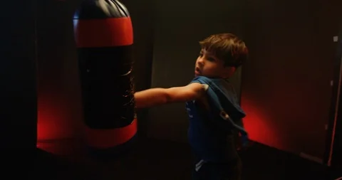 Little boy practice boxing on punching bag Video stock 112074921