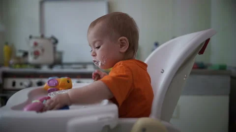 Little boy practices eating in the kitchen  4 - Without color correction Stock Footage 55102389