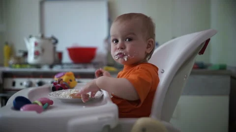 Little boy practices eating in the kitchen 5  - Without color correction Stock Footage 55102814
