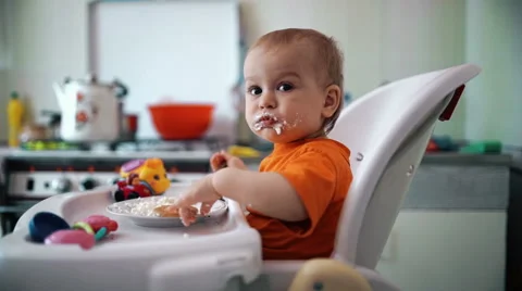 Little boy practices eating in the kitchen 4  - Color corrected Stock-Footage 55102878