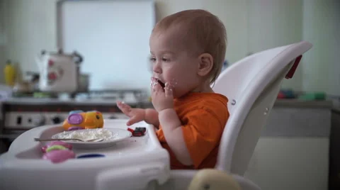 Little boy practices eating in the kitchen  2 - Without color correction Stock Footage 55103692