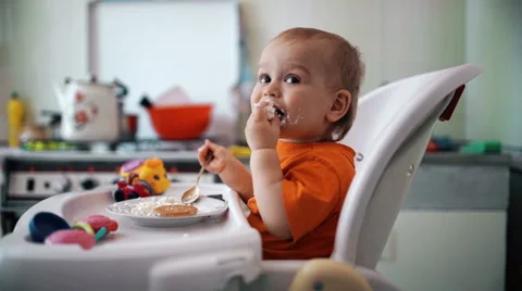 Little boy practices eating in the kitchen 5  - Color corrected Stock Footage 55103950
