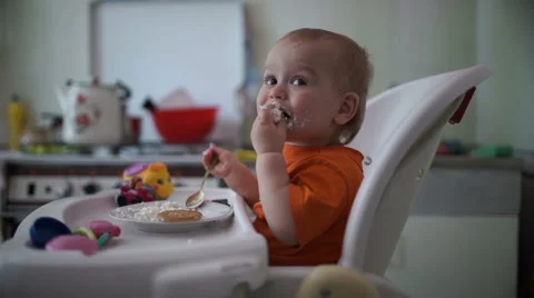 Little boy practices eating in the kitchen 6  - Without color correction Stock Footage 55103952