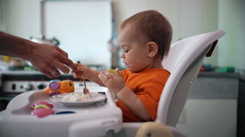 Little boy practices eating in the kitchen 2  - Color corrected Stock Footage 55104262