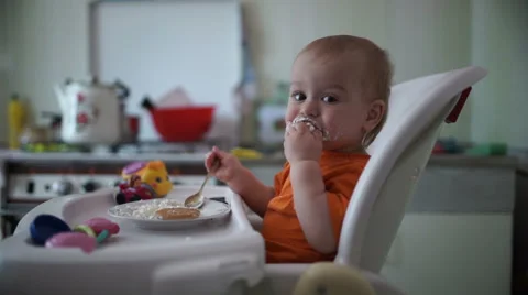 Little boy practices eating in the kitchen 7  - Without color correction Video stock 55104989