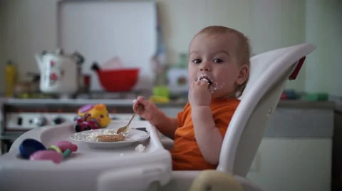 Little boy practices eating in the kitchen  8 - Without color correction Stock-Footage 55105381