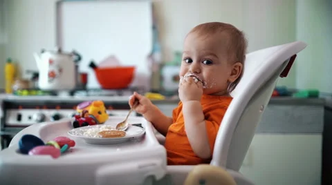 Little boy practices eating in the kitchen 6  - Color corrected Stock-Footage 55105459