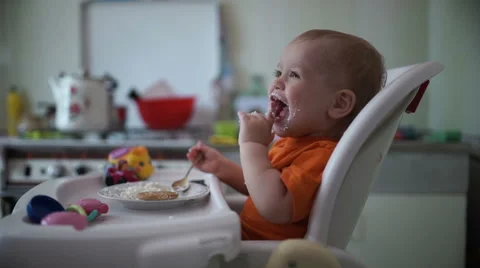 Little boy practices eating in the kitchen 10  - Without color correction Stock-Footage 55106062