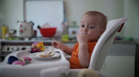 Little boy practices eating in the kitchen 9  - Without color correction Stock-Footage 55106529