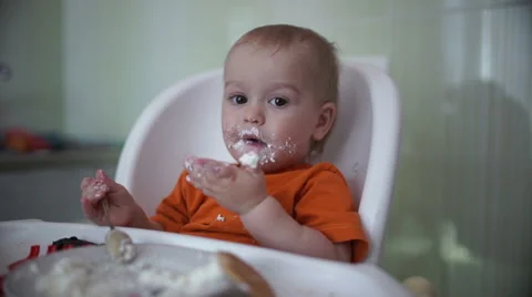 Little boy practices eating in the kitchen 12  - Without color correction Stock Footage 55107031