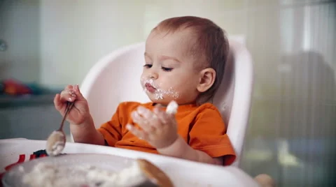 Little boy practices eating in the kitchen 10  - Color corrected Stock-Footage 55107169