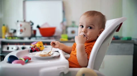 Little boy practices eating in the kitchen 7  - Color corrected Stock-Footage 55107275