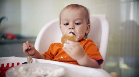 Little boy practices eating in the kitchen 13  - Color corrected Stock Footage 55107737