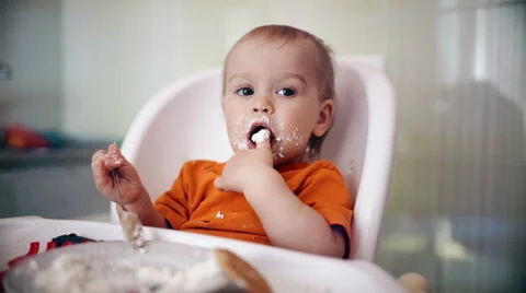 Little boy practices eating in the kitchen 11  - Color corrected Video stock 55108228