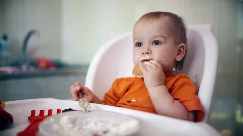 Little boy practices eating in the kitchen 14  - Color corrected Stock Footage 55108360
