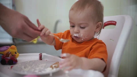 Little boy practices eating in the kitchen 19  - Without color correction Video stock 55108983