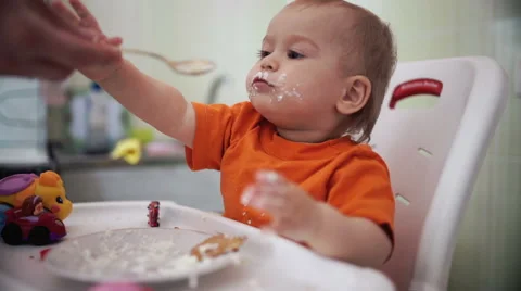Little boy practices eating in the kitchen 18  - Color corrected Video stock 55108993
