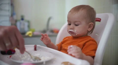 Little boy practices eating in the kitchen 20  - Without color correction Video stock 55109304