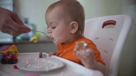 Little boy practices eating in the kitchen 21  - Without color correction Video stock 55109647