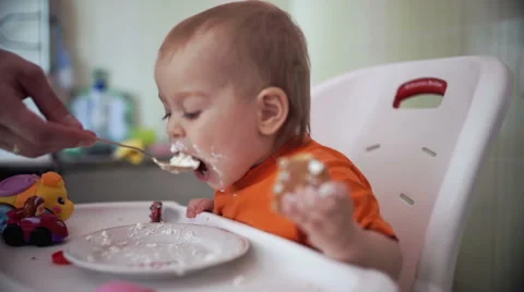 Little boy practices eating in the kitchen 20  - Color corrected Stock-Footage 55109729