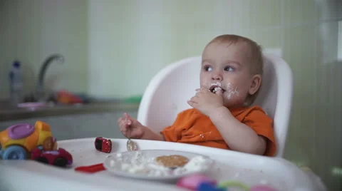 Little boy practices eating in the kitchen 18  - Without color correction Stock Footage 55110482