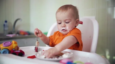 Little boy practices eating in the kitchen 17  - Color corrected Stock Footage 55110537