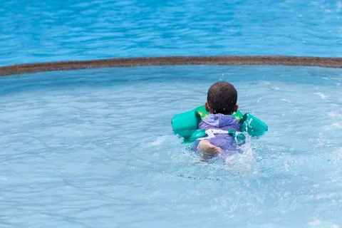 Little boy practicing swimming in the pool. Stock Photos